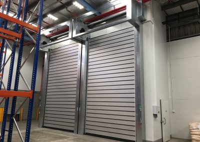 Insulated roll doors for chiller enclosures